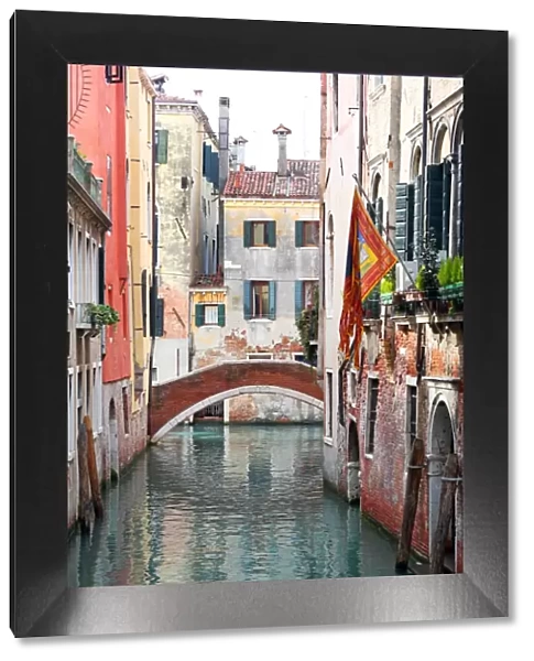 Buildings along a canal with a bridge in Venice, Italy