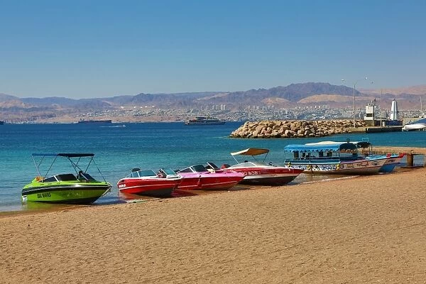 The beach at Aqaba in Jordan looking towards Eilat in Israel