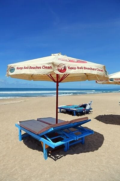 Beach umbrellas and deckchairs on Legian Beach, Denpasar, Bali, Indonesia