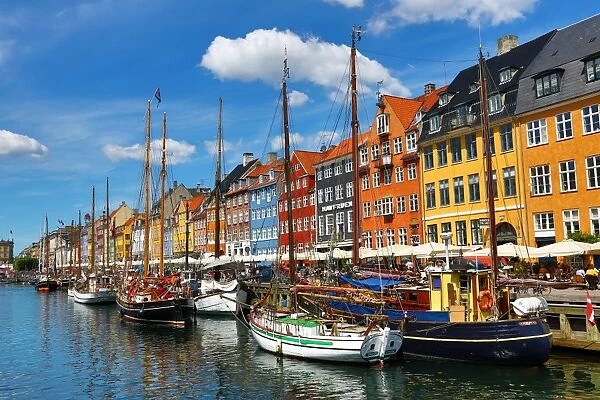 Boats and colourful houses at Nyhavn Quay in Copenhagen, Denmark