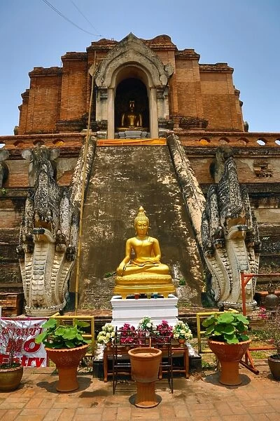 Gold Buddha statue and the Chedi at the Wat Chedi Luang Temple in Chiang Mai, Thailand