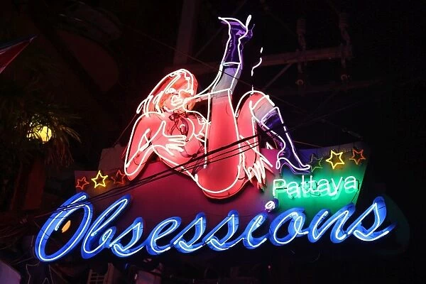 Night scene of illuminated neon signs of Obsessions Gogo Bar in Boyz Town in the Red Light District of Pattaya, Thailand