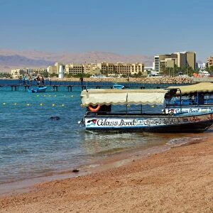 The beach at Aqaba in Jordan looking towards Eilat in Israel