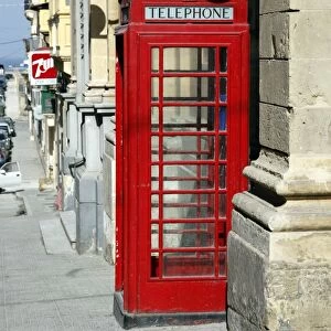 Red English telephone box in the street in Valletta, Malta