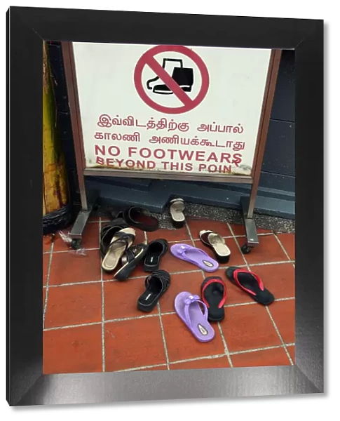 No footwear sign and shoes outside a temple in Singapore, Republic of Singapore