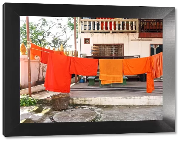 Orange Buddhist Monk clothes and robes on a washing line, Vientiane, Laos