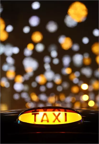 Black taxi cab sign Oxford Street Christmas lights in London