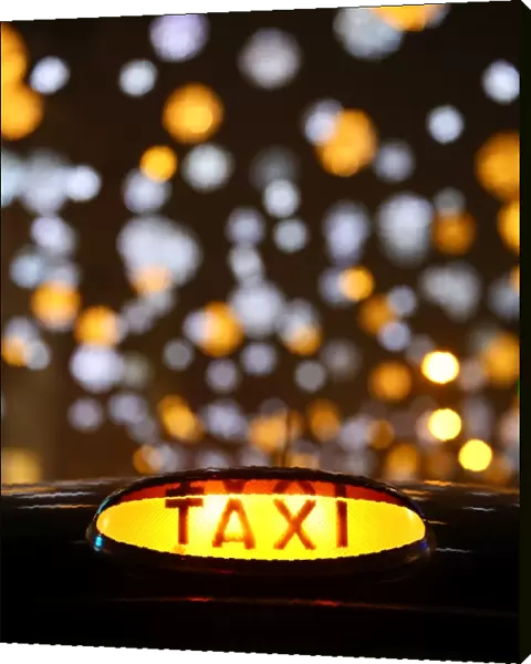 Black taxi cab sign Oxford Street Christmas lights in London