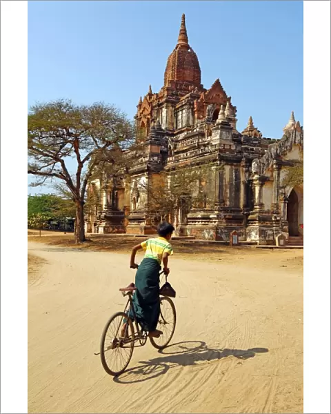 Cyclist at Thatthe Mokgo Hpaya Pagoda in Nuang U, Bagan, Myanmar (Burma)