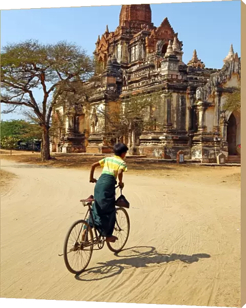 Cyclist at Thatthe Mokgo Hpaya Pagoda in Nuang U, Bagan, Myanmar (Burma)