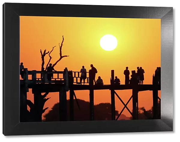 Silhouettes on the U Bein Bridge at sunset, Amarapura, Myanmar