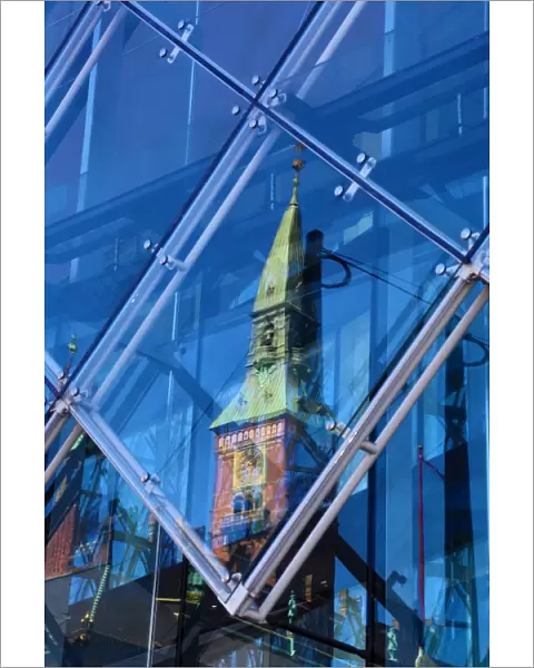 Scandic Hotel clock tower reflected in a diamond shaped glass window in Copenhagen