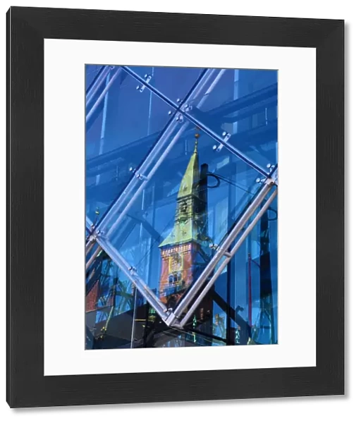Scandic Hotel clock tower reflected in a diamond shaped glass window in Copenhagen