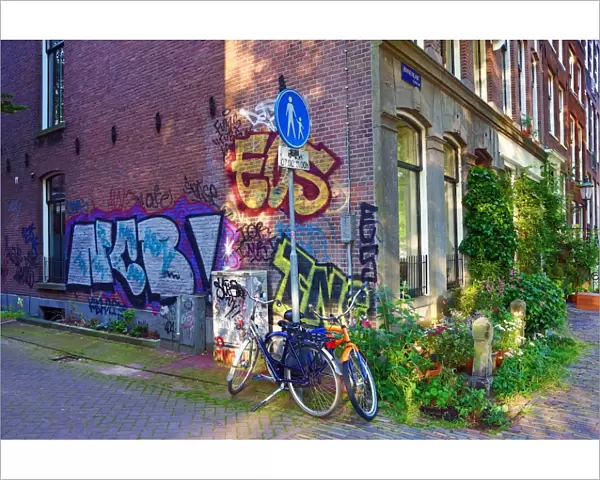 Bicycles parked in the street with grafitti in Amsterdam, Holland