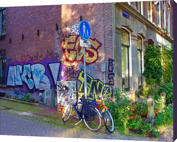 Bicycles parked in the street with grafitti in Amsterdam, Holland