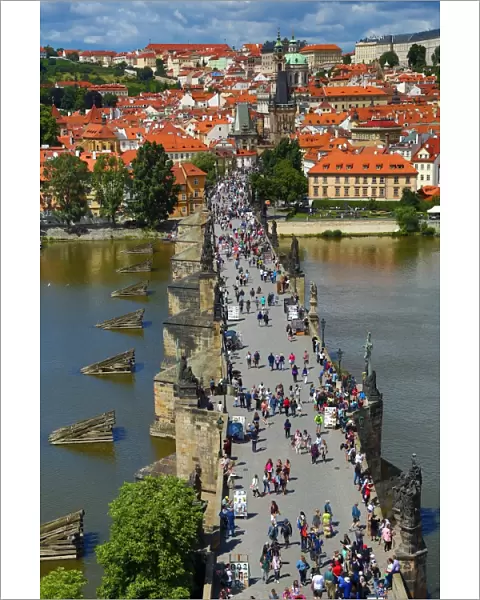 Tourists walking over the Charles Bridge over the Vltava River in Prague, Czech Republic