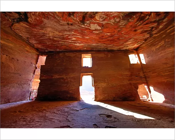 Light streaming through the windows of the Urn Tomb of the Royal Tombs in the rock city of Petra
