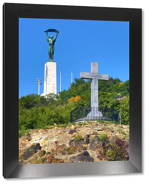 The Liberty Statue and Cross Monument on Gellert Hill in Budapest, Hungary