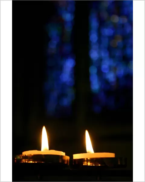 Candles and stained glass window