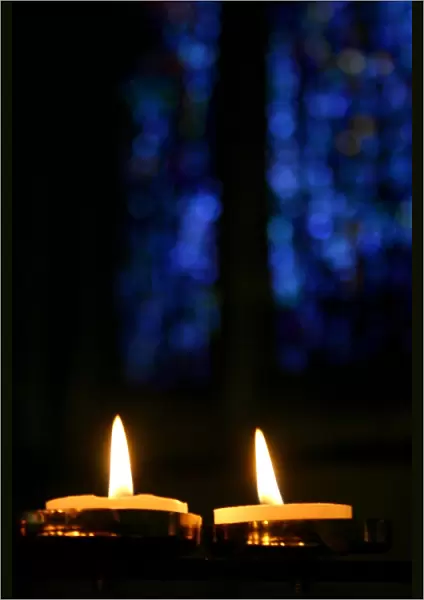 Candles and stained glass window