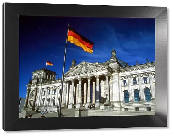 The Reichstag building and German flag, Berlin, Germany