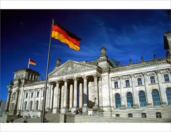 The Reichstag building and German flag, Berlin, Germany