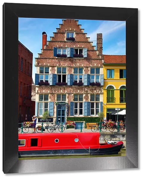 Traditional building and houseboat on a canal, Ghent, Belgium