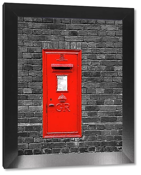 Red English Post Box in a brick wall