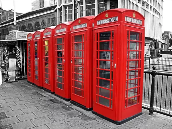 Line of red telephone boxes in London, England, spot colour