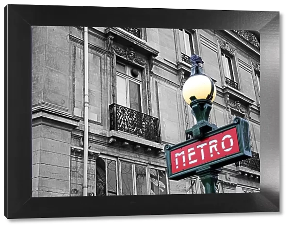 Red French Metro subway sign in the street in Paris, France, spot colour