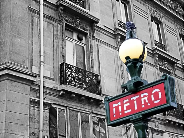 Red French Metro subway sign in the street in Paris, France, spot colour