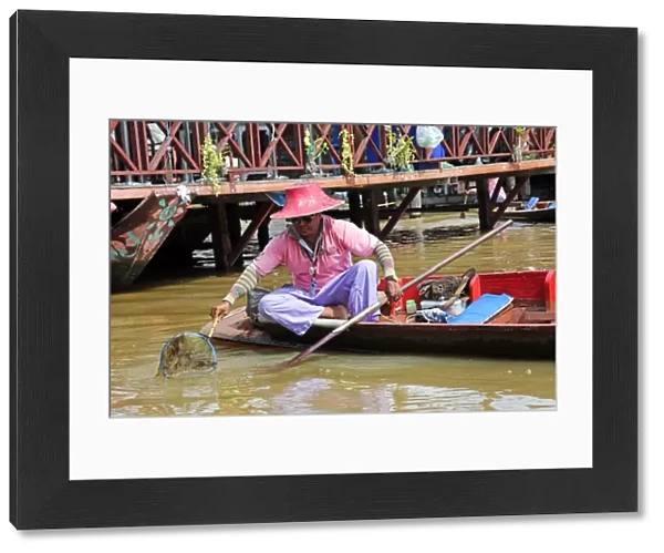 Man fishing from boat at Pattaya Floating Market in Pattaya, Thailand