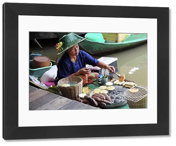 Woman cooking on a Fast Food stall at Pattaya Floating Market in Pattaya, Thailand