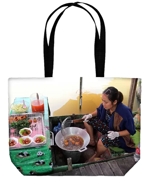 Woman cooking on a Fast Food stall at Pattaya Floating Market in Pattaya, Thailand