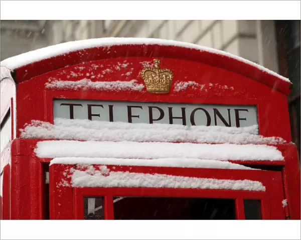 Snow on a red telephone box, London