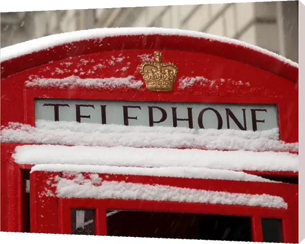 Snow on a red telephone box, London
