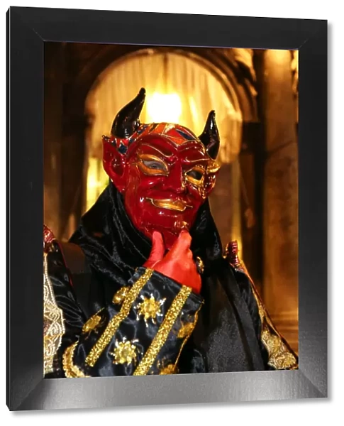Person wearing a demon mask and costume at the Venice Carnival