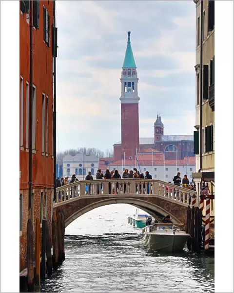 Bridge over a canal and San Giorgio Maggiore in Venice, Italy
