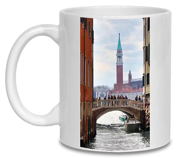 Bridge over a canal and San Giorgio Maggiore in Venice, Italy