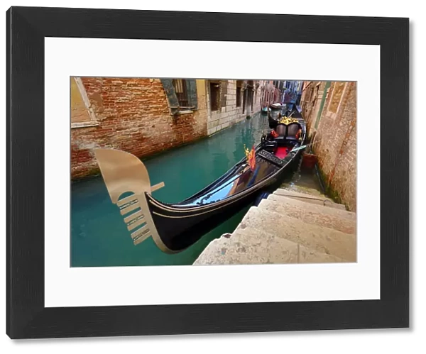 Gondola moored in a canal, in Venice, Italy