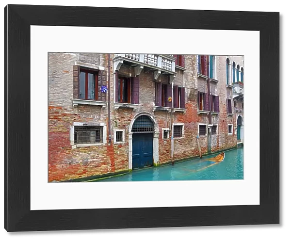 Doorway of a building on a canal in Venice, Italy