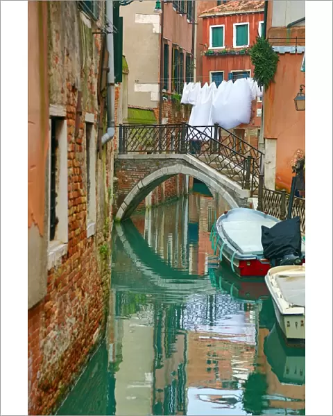 Bridge over a canal and washing in Venice, Italy