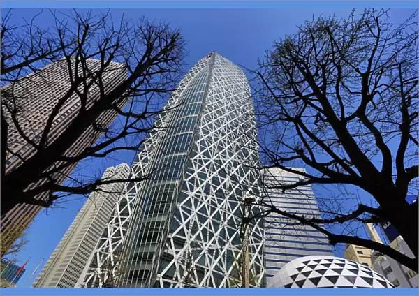Mode Gakuen Cocoon Tower building and silhouettes of trees in Tokyo, Japan