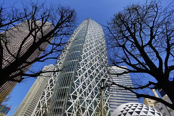 Mode Gakuen Cocoon Tower building and silhouettes of trees in Tokyo, Japan