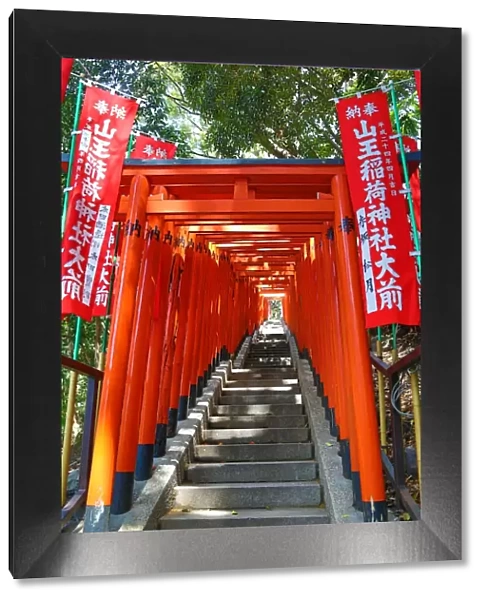 Red Torii gates and steps to the entrance to the Hie-Jinja Shinto Shrine in Tokyo, Japan