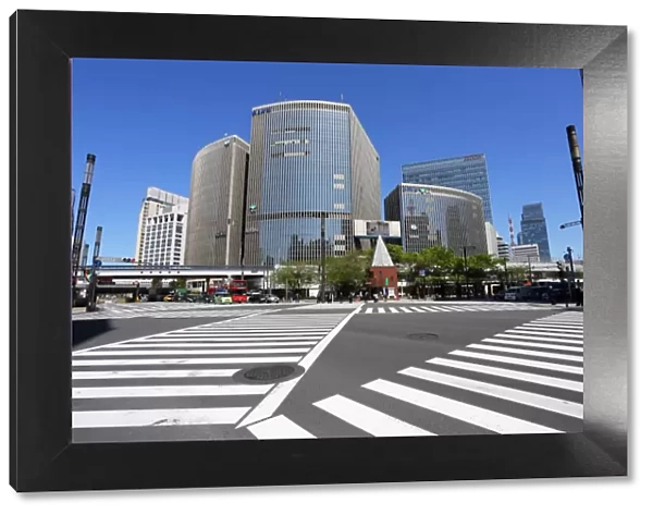 Japanese street scene of modern buildings and a pedestrian crossing in Ginza, Tokyo, Japan