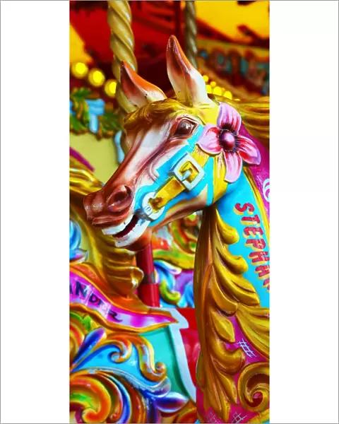 Colourful painted horses on a fairground carousel