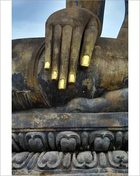 Hand on a Buddha statue at Wat Mahathat temple, Sukhotai, Thailand