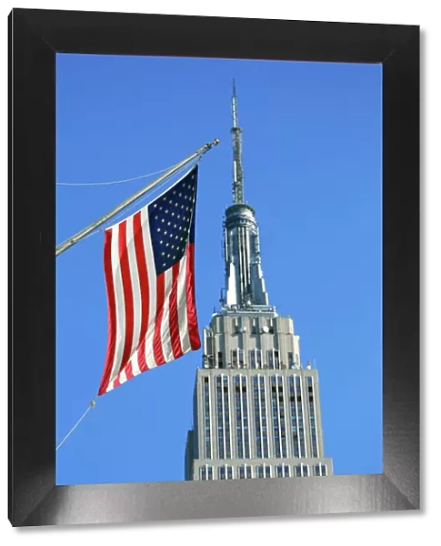 The Empire State Building and Stars and Stripes American flag, New York. America