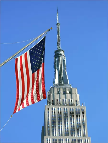 The Empire State Building and Stars and Stripes American flag, New York. America